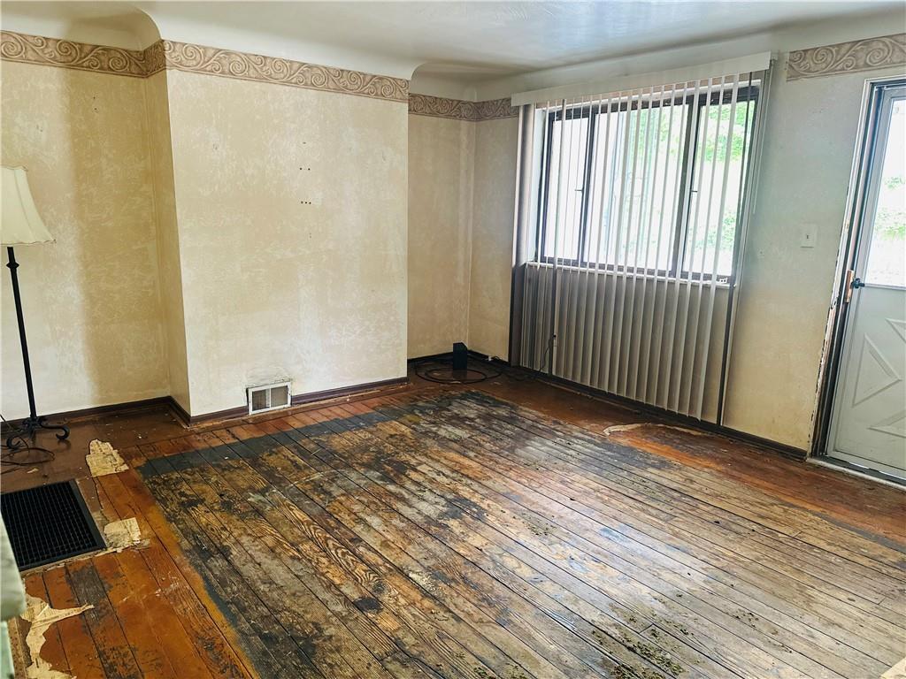 1421 Ridge Avenue Braddock, PA 15104 - Photo 2 of 8 a view of a room with wooden floor and chair
