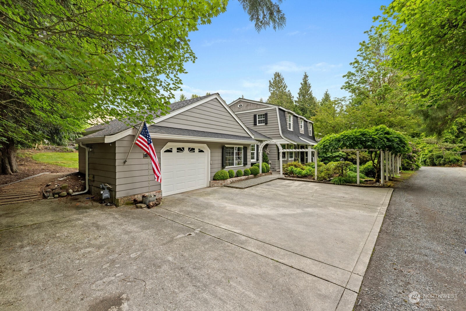 525 192nd Place Southeast Bothell, WA 98012 - Photo 3 of 40 a view of a house with a yard and large trees