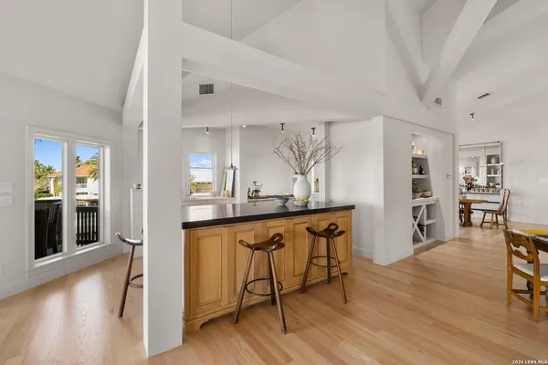 a kitchen with granite countertop a sink appliances and cabinets