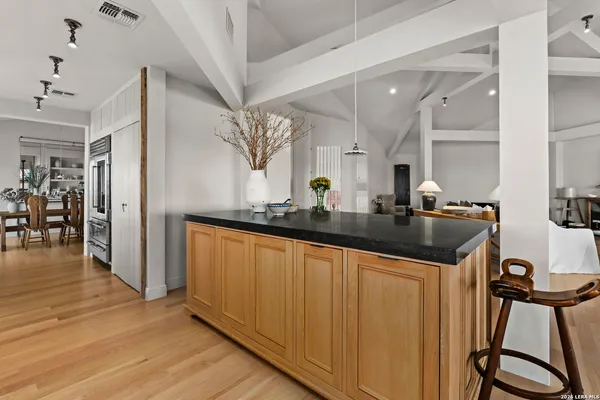 a kitchen with stainless steel appliances granite countertop a refrigerator and a sink