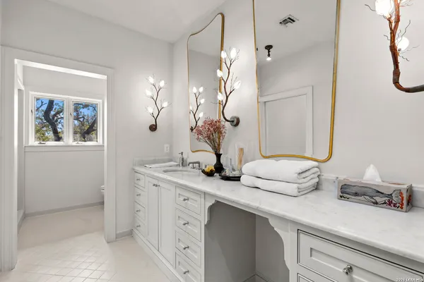 a bathroom with a double vanity sink and a mirror