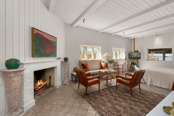 a living room with furniture a rug and a window