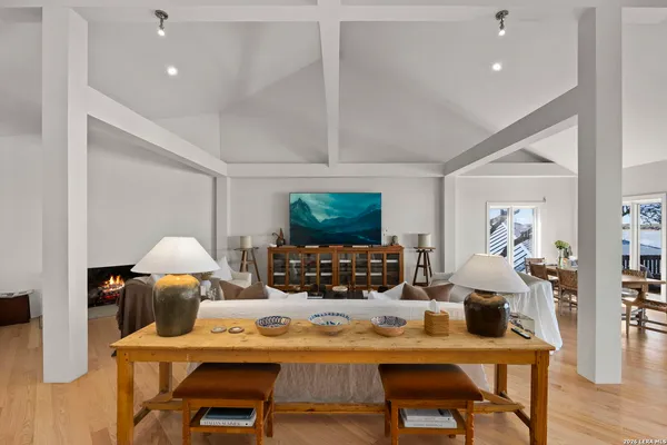 a living room with furniture a flat screen tv and a fireplace