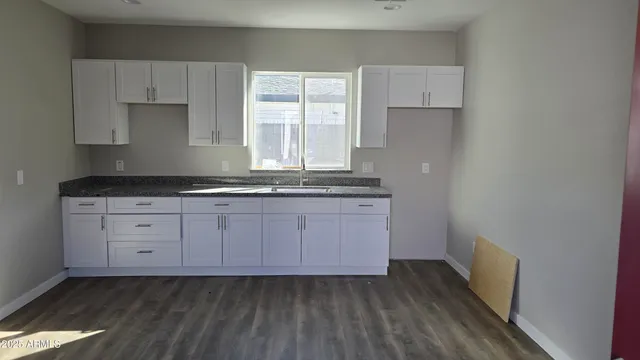 a kitchen with cabinets appliances and a window