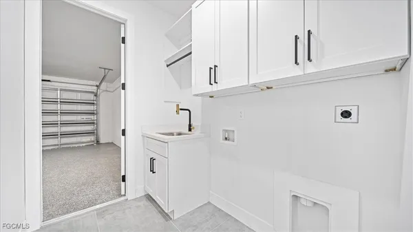 a view of cabinets and entryway with white walls
