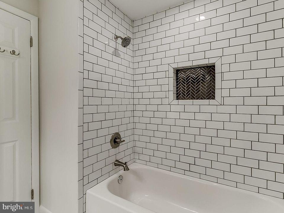 136 Welcome Alley, Unit TH2 Baltimore, MD 21201 - Photo 19 of 39 Sleek subway tile bath retreat.