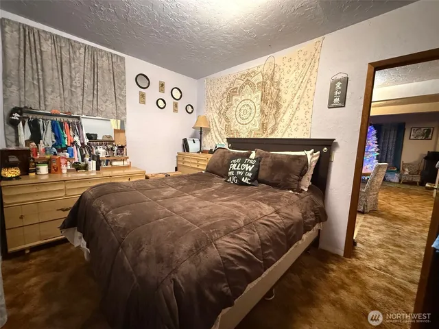 a bed sitting in a bedroom and painting on the wall