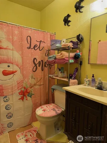 a bathroom with a sink mirror vanity and toilet