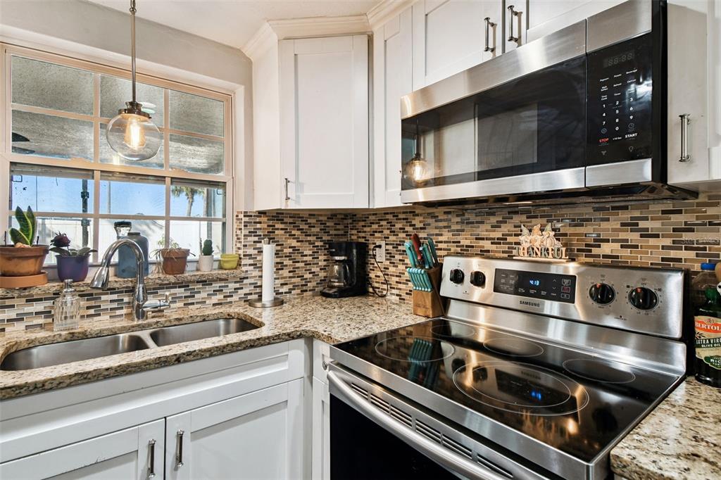 5831 1st Avenue New Port Richey, FL 34652 - Photo 8 of 22 a kitchen with a stove and a microwave