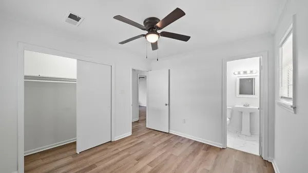 a view of empty room with wooden floor