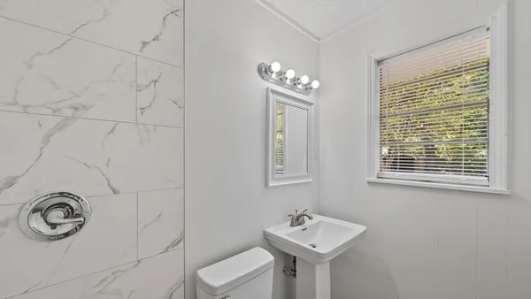 a bathroom with a sink toilet and shower