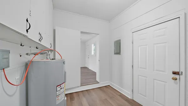 a view of a hardwood & utility room