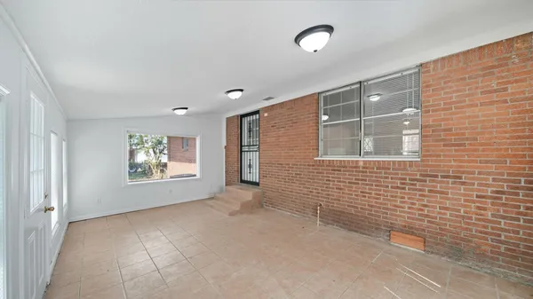 a view of an empty room with windows