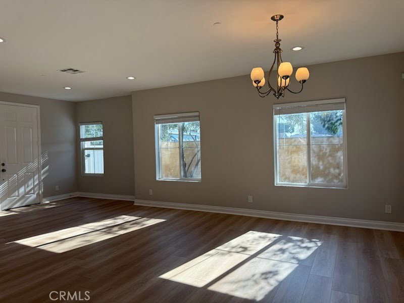 8724 Ramona Street, Unit 4 Bellflower, CA 90706 - Photo 2 of 7 a view of an empty room with wooden floor and a window