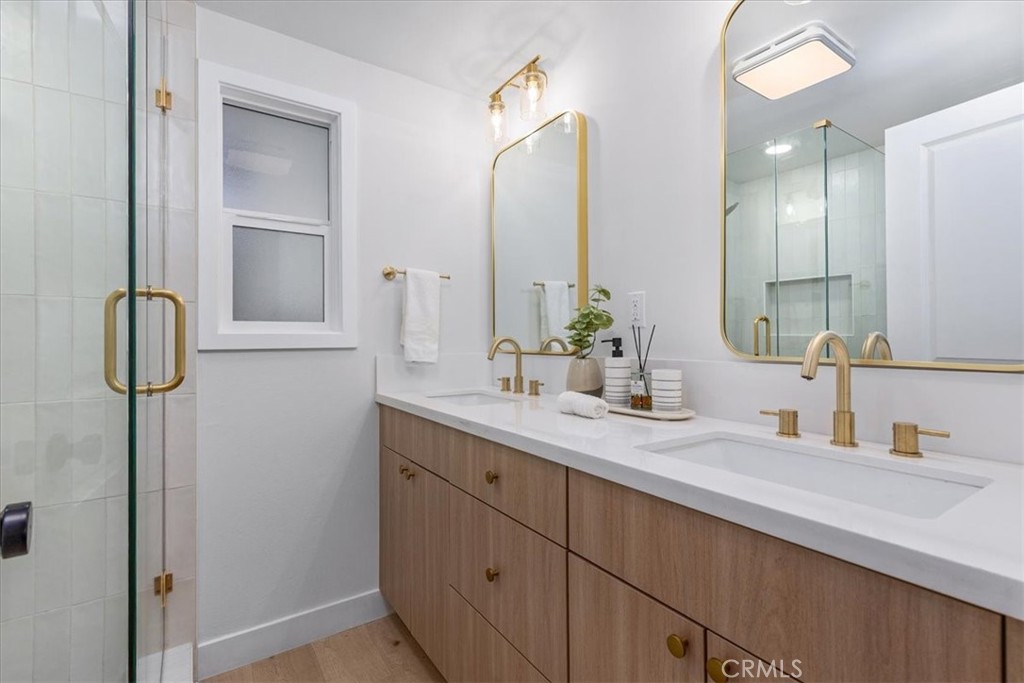 26002 Adamor Road Calabasas, CA 91302 - Photo 17 of 39 a bathroom with a double vanity sink and a mirror