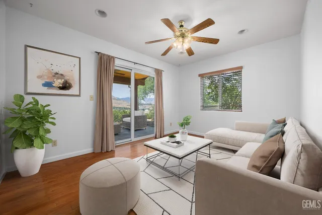 a living room with furniture and a potted plant