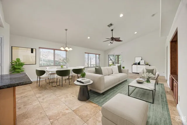 a living room with furniture and a chandelier