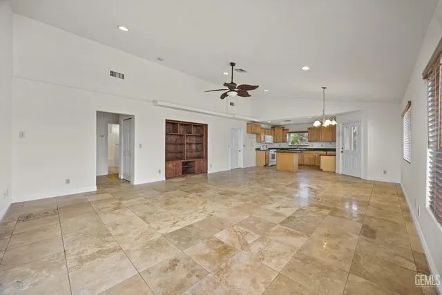 a view of a kitchen with a sink and a refrigerator