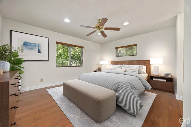 a bedroom with a large bed couch and a window