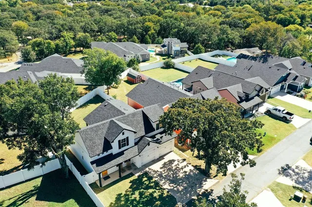 an aerial view of a house with swimming pool and garden view