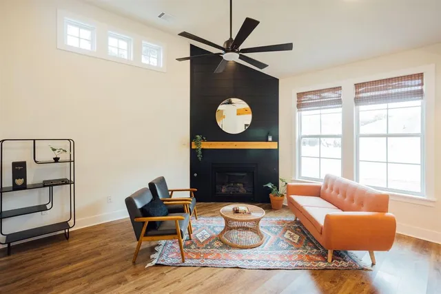 a living room with furniture a fireplace and window