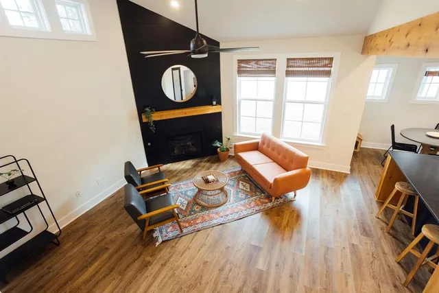 a living room with furniture and a wooden floor