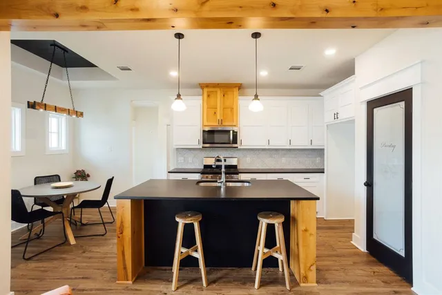 a view of a dining room with furniture and wooden floor