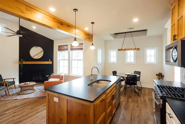 a kitchen with a counter space a sink appliances and cabinets