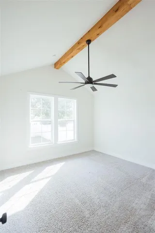 an empty room with a window and a ceiling fan