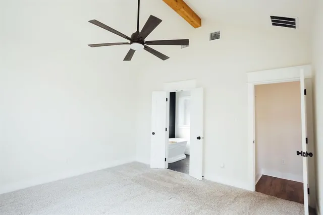 a view of a livingroom with a ceiling fan and wooden floor