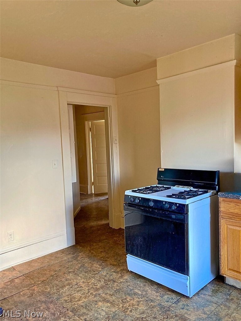 554 Eddy Road Cleveland, OH 44108 - Photo 29 of 32 2nd Floor- Kitchen featuring range with gas stovetop and baseboards