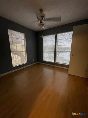 an empty room with windows and closet
