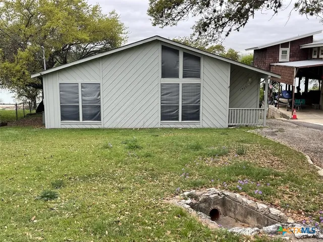 a backyard of a house with yard and garage
