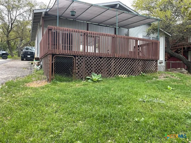a view of a backyard with a small cabin and wooden fence