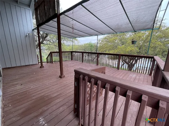 a view of porch with wooden deck and furniture