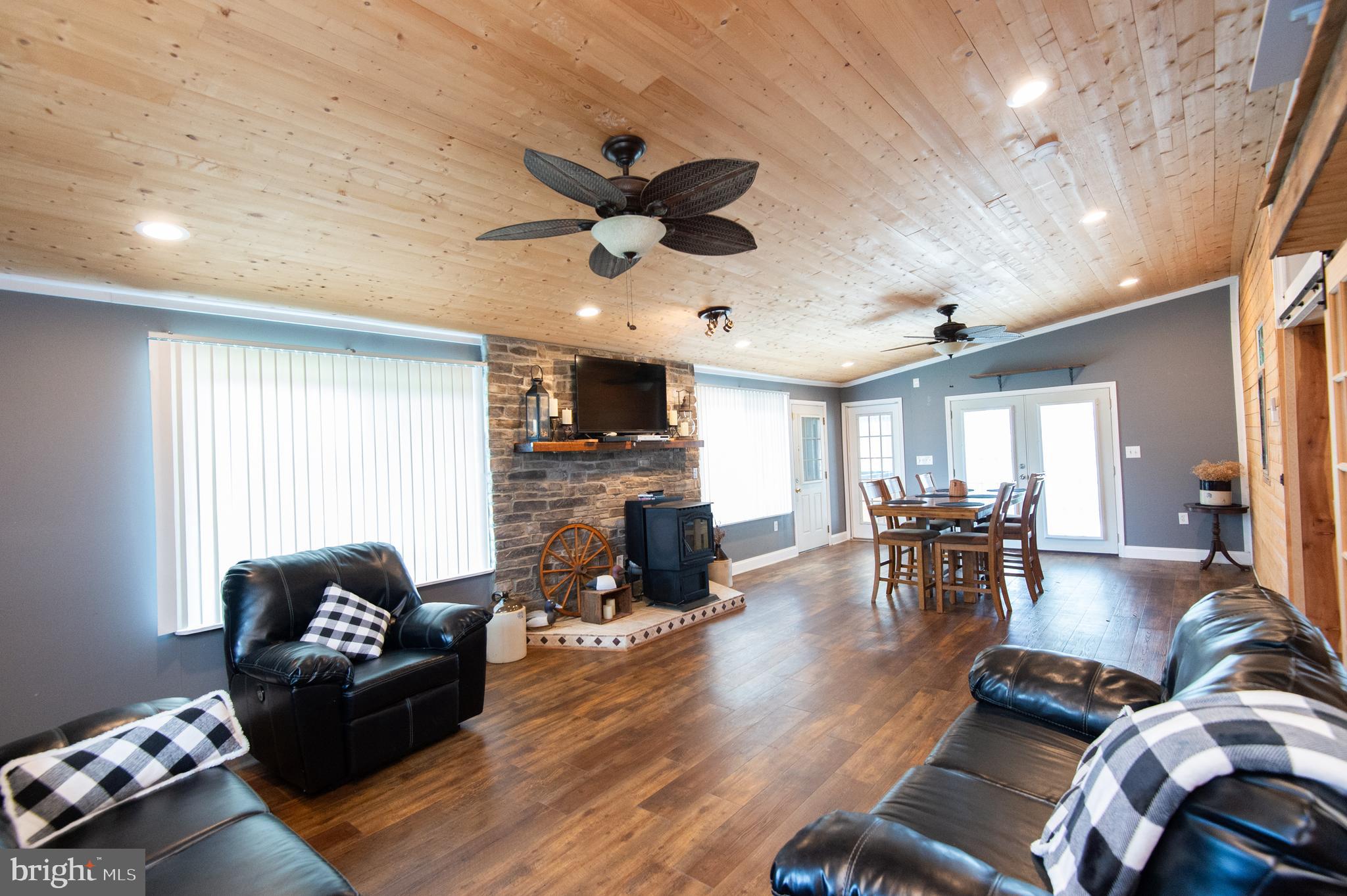 2407 Hoopers Island Road Fishing Creek, MD 21634 - Photo 11 of 69 Sunroom with pellet stove and stone hearth