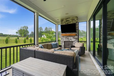 a balcony with furniture and a fireplace