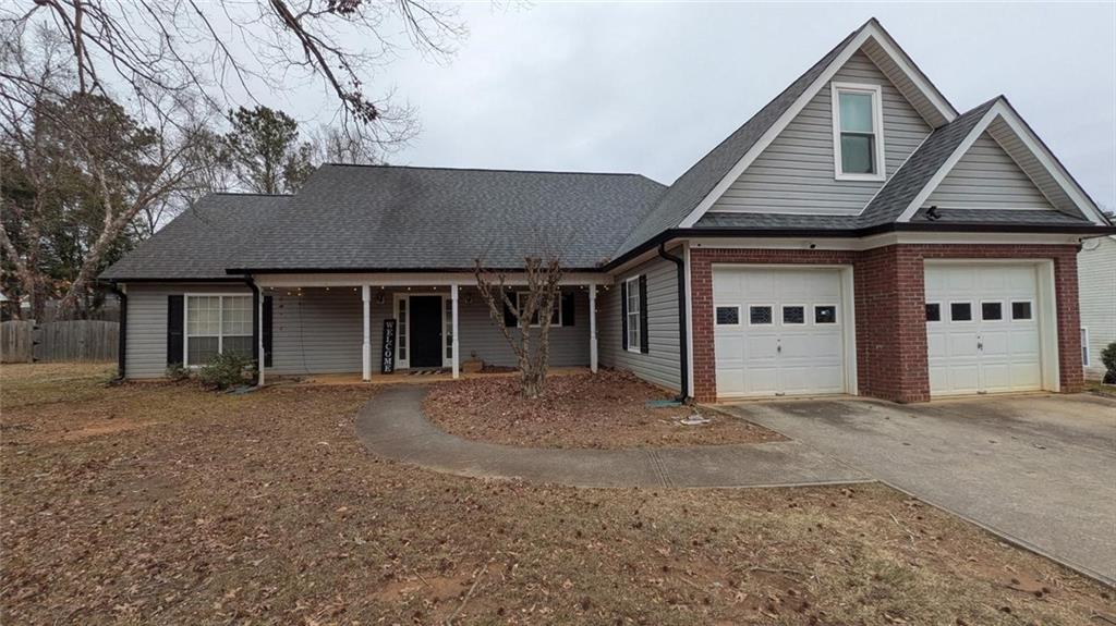230 Overlook Drive Covington, GA 30016 - Photo 2 of 34 a front view of a house with a yard and garage