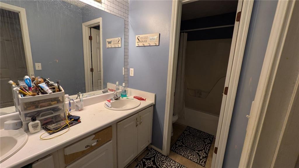 230 Overlook Drive Covington, GA 30016 - Photo 26 of 34 a bathroom with a sink and a mirror