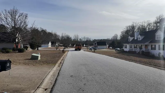 a view of a house with a yard and garage