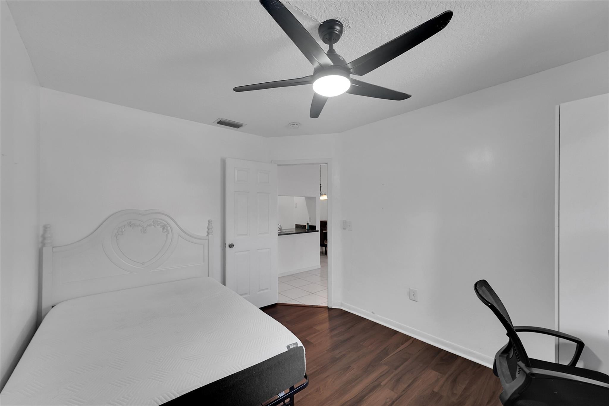 2698 North Nob Hill Road Sunrise, FL 33322 - Photo 12 of 27 a view of a room with wooden floor and ceiling fan