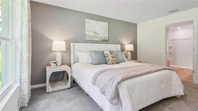 a bedroom with a bed and a window