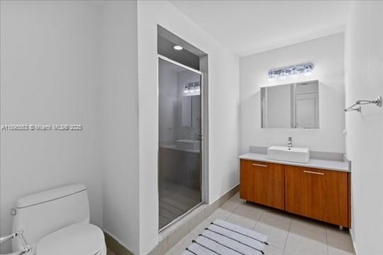 3301 Northeast 1st Avenue, Unit L0202 Miami, FL 33137 - Photo 6 of 25 a bathroom with a granite countertop sink mirror vanity and toilet
