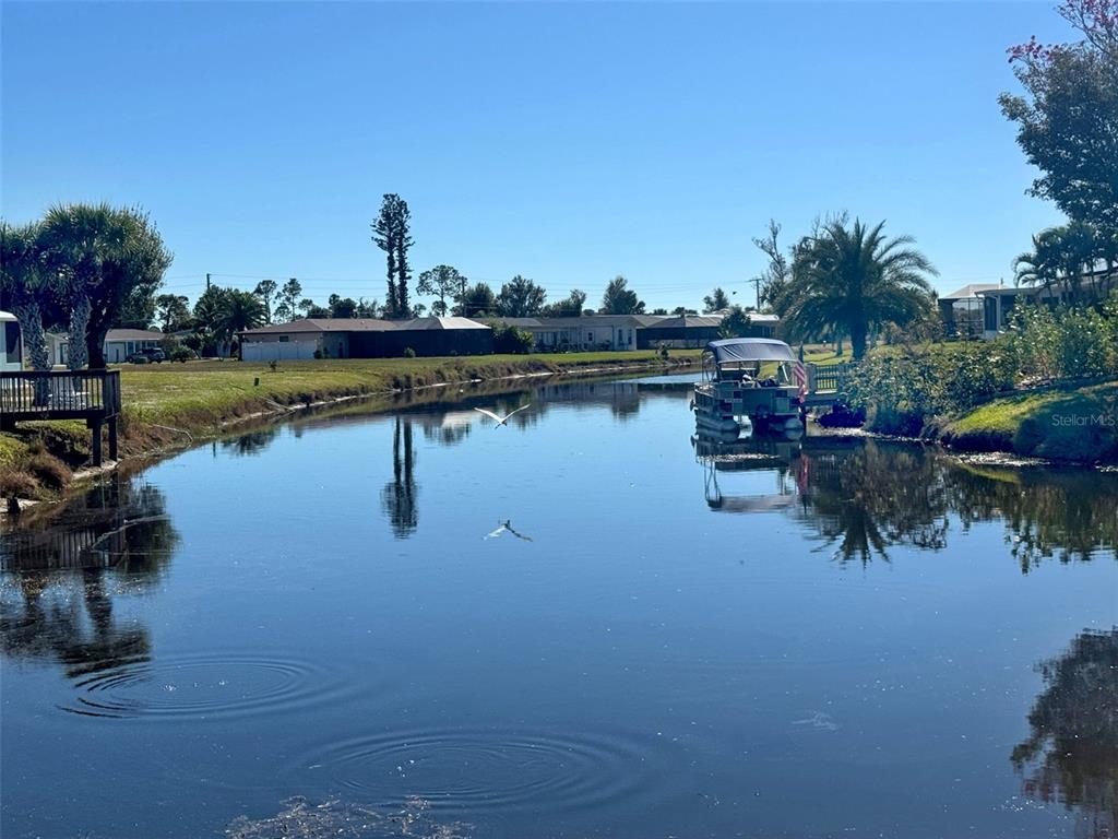 151 Caddy Road Rotonda West, FL 33947 - Photo 11 of 12 a view of a lake with houses