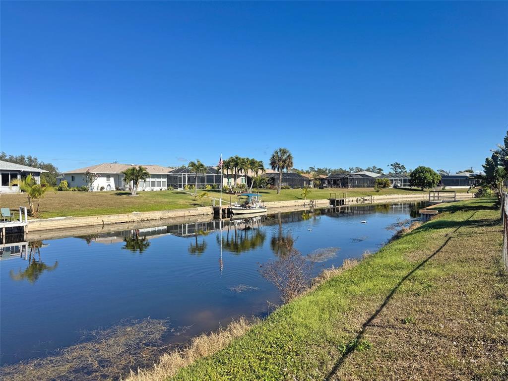 151 Caddy Road Rotonda West, FL 33947 - Photo 3 of 12 a view of a lake with boats and trees in the background