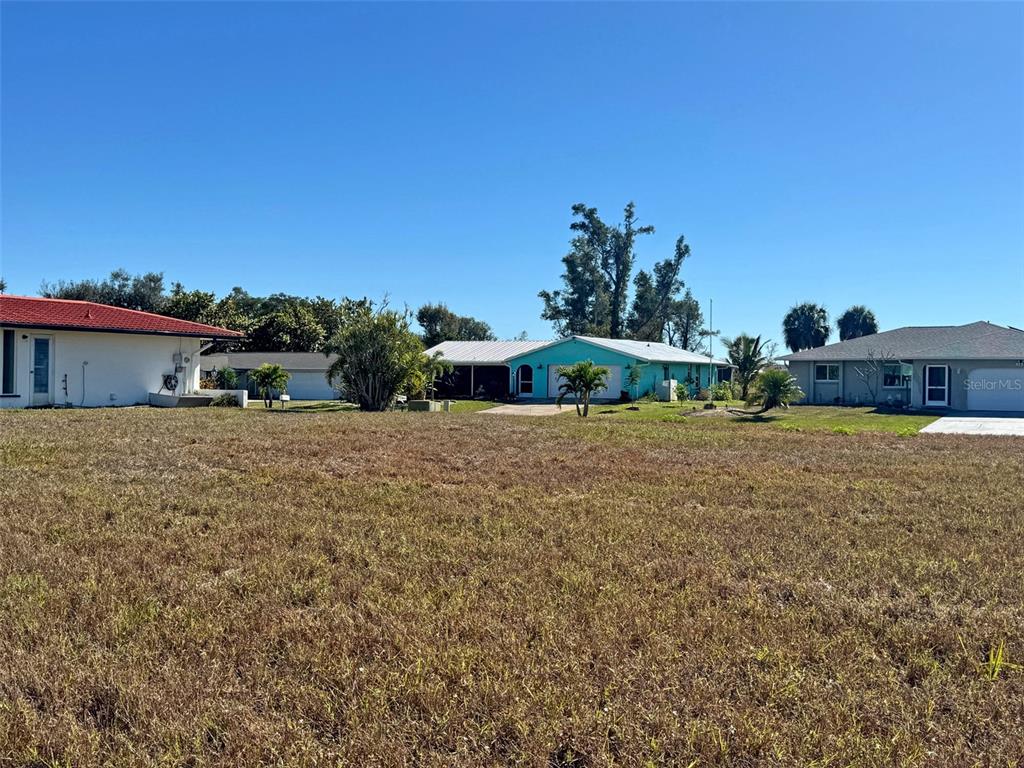 151 Caddy Road Rotonda West, FL 33947 - Photo 7 of 12 a front view of a house with a yard