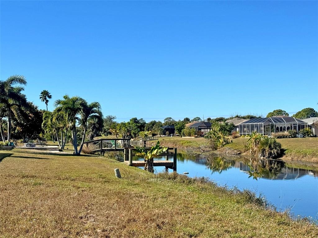 151 Caddy Road Rotonda West, FL 33947 - Photo 10 of 12 a view of a lake with beach