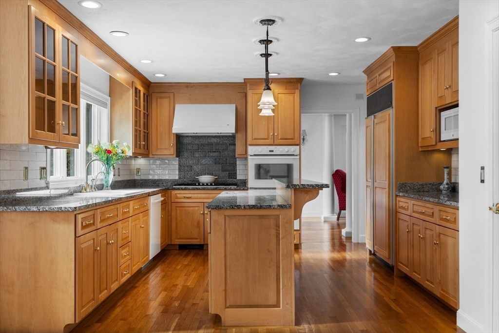 15 Stafford Road Lynnfield, MA 01940 - Photo 12 of 39 a kitchen with kitchen island granite countertop wooden floors and stainless steel appliances