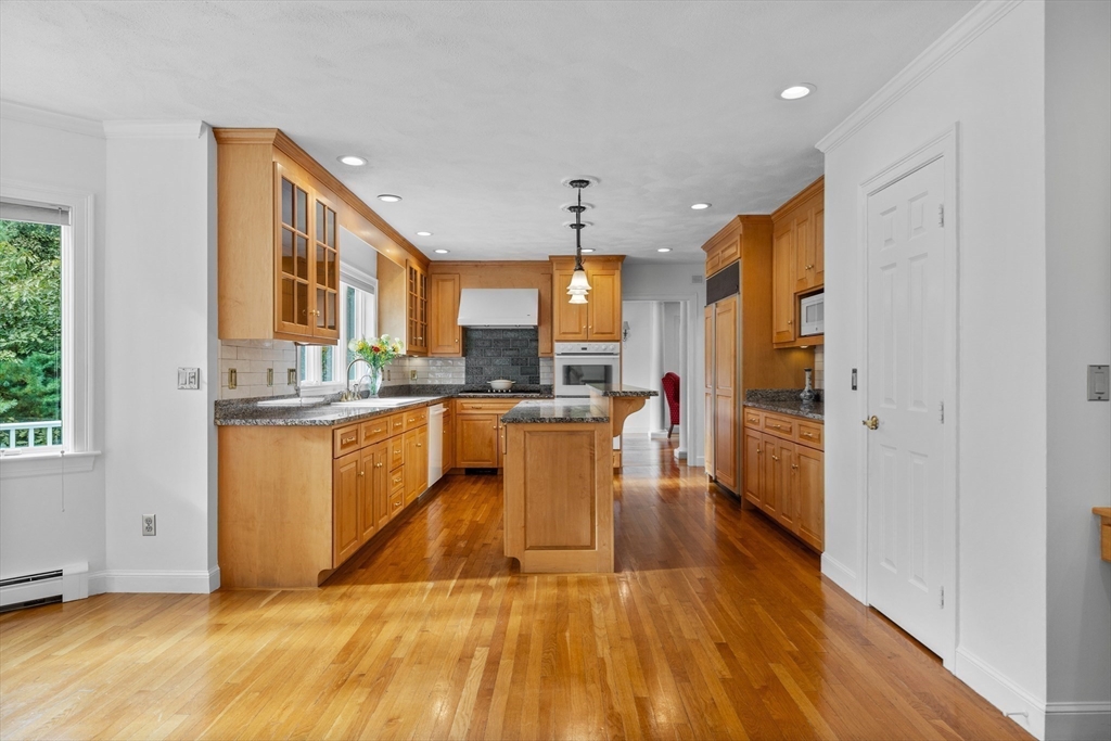 15 Stafford Road Lynnfield, MA 01940 - Photo 13 of 39 a kitchen with stainless steel appliances granite countertop a refrigerator a sink dishwasher and a stove with wooden floor