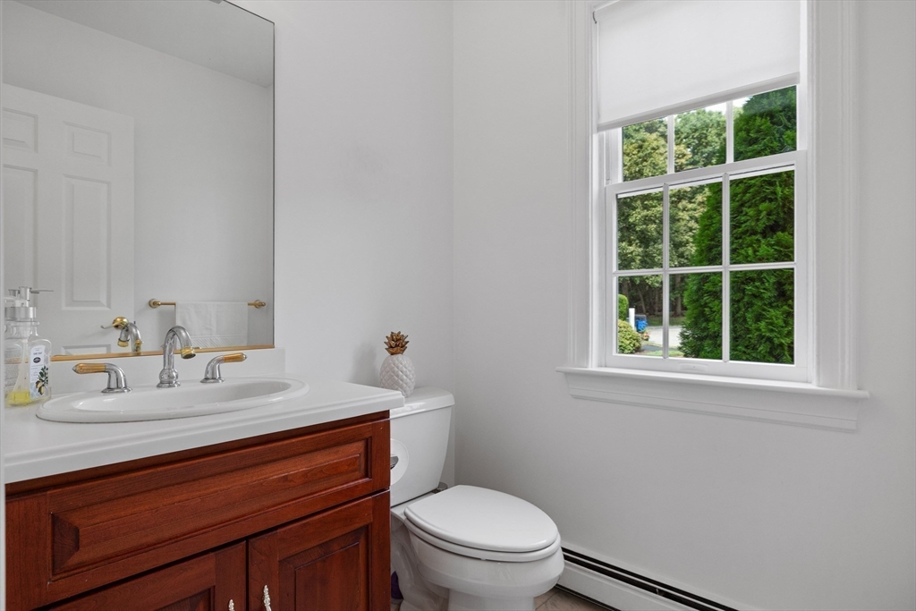 15 Stafford Road Lynnfield, MA 01940 - Photo 18 of 39 a bathroom with a toilet sink vanity and mirror